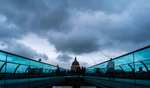 Low angle view of bridge against cloudy sky