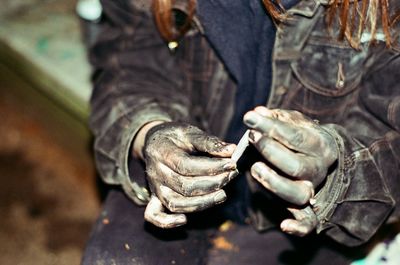 Midsection of woman with dirty hands