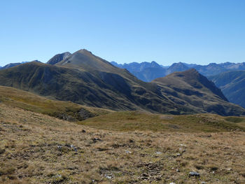 Scenic view of mountains against clear blue sky