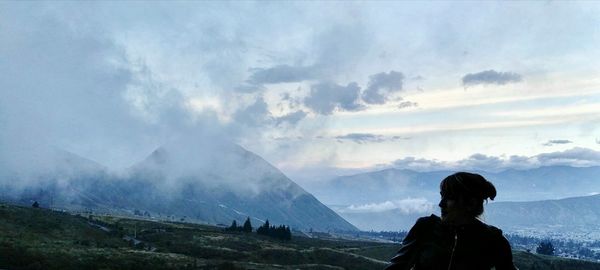 Silhouette woman standing against mountains