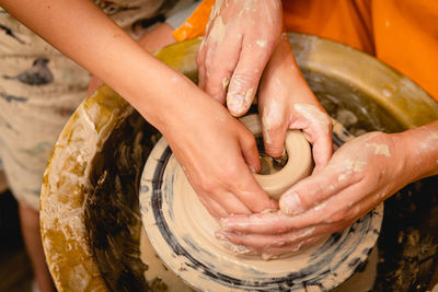 Cropped image of person making pottery