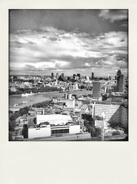 Cityscape against cloudy sky