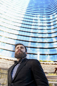 Young businessman in a glass skyscraper