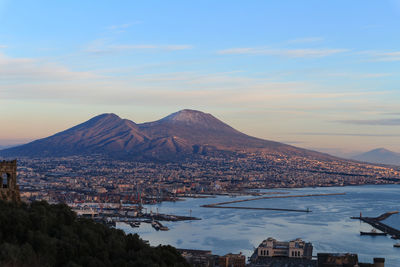 City by mountains against sky