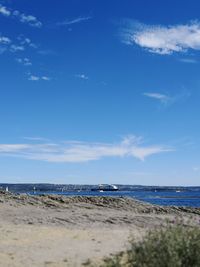 Scenic view of beach against blue sky