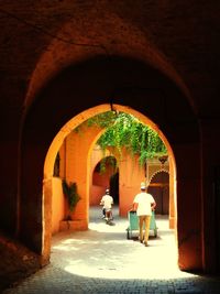 Woman sitting in archway