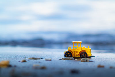 Close-up of toy car on the beach