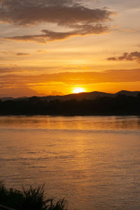 Scenic view of lake against romantic sky at sunset
