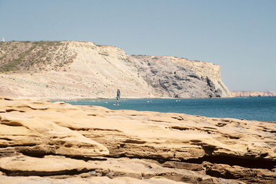 Scenic view of beach against clear sky