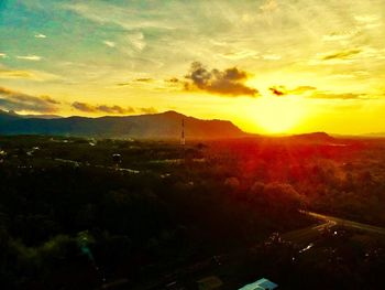 Scenic view of field against sky during sunset