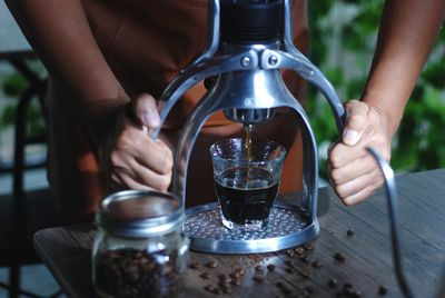 Barista make cup of coffee with manual press 