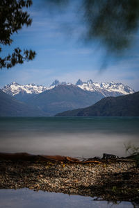 Scenic view of sea and mountains against sky