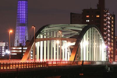 Low angle view of illuminated bridge at night