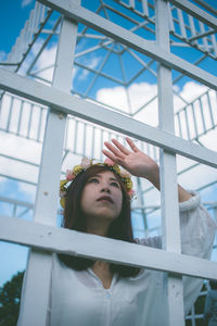 Woman looking through window in city