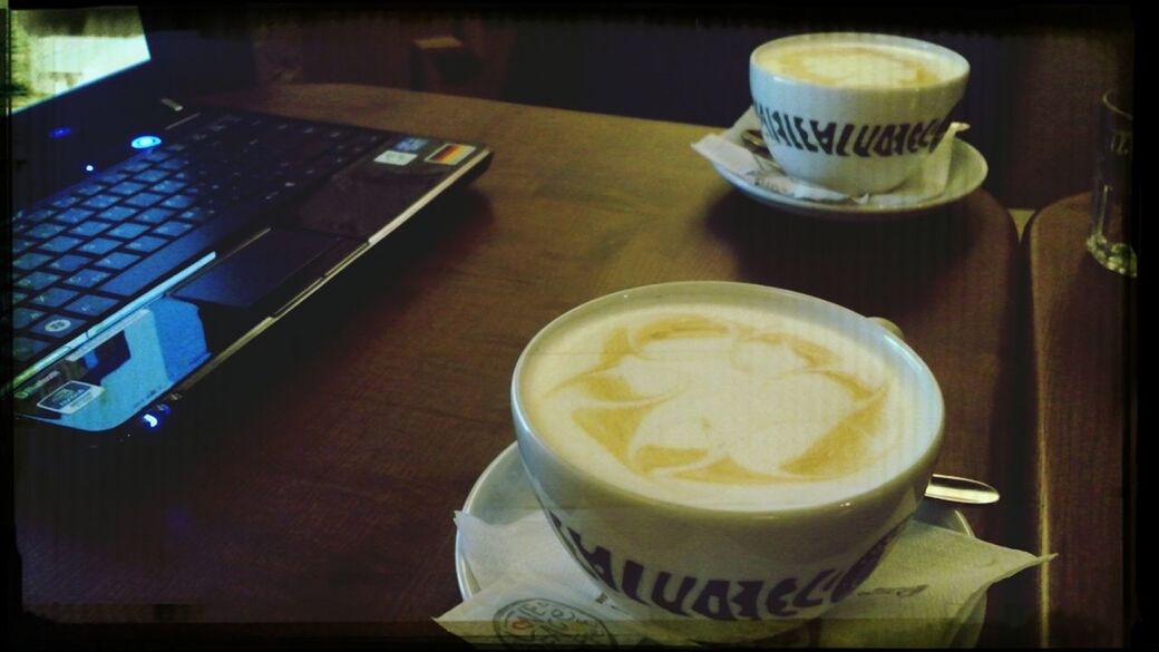 coffee cup, table, drink, food and drink, indoors, refreshment, coffee - drink, saucer, coffee, freshness, cup, still life, frothy drink, cappuccino, close-up, froth art, cafe, spoon, high angle view, auto post production filter