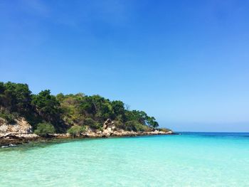 Scenic view of sea against clear blue sky