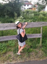 Full length of smiling girl standing on grass