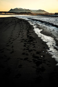 Scenic view of beach against sky during sunset