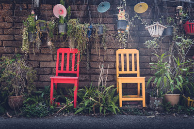 Empty chairs and tables in yard