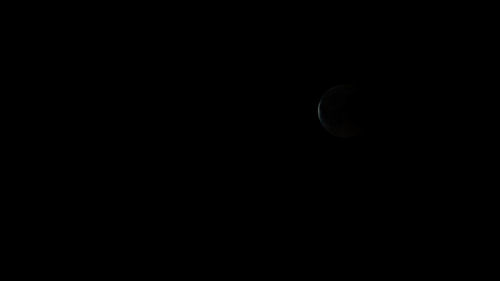 Low angle view of moon against sky at night