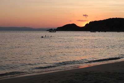 Scenic view of sea against orange sky