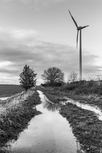 Traditional windmill on field against sky