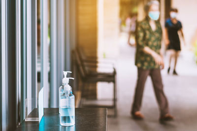 Woman standing by window at home