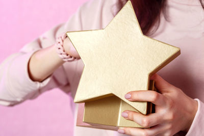 Midsection of woman holding book