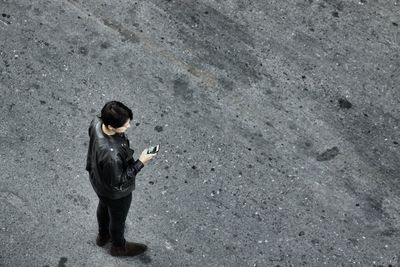 High angle view of man standing on sand