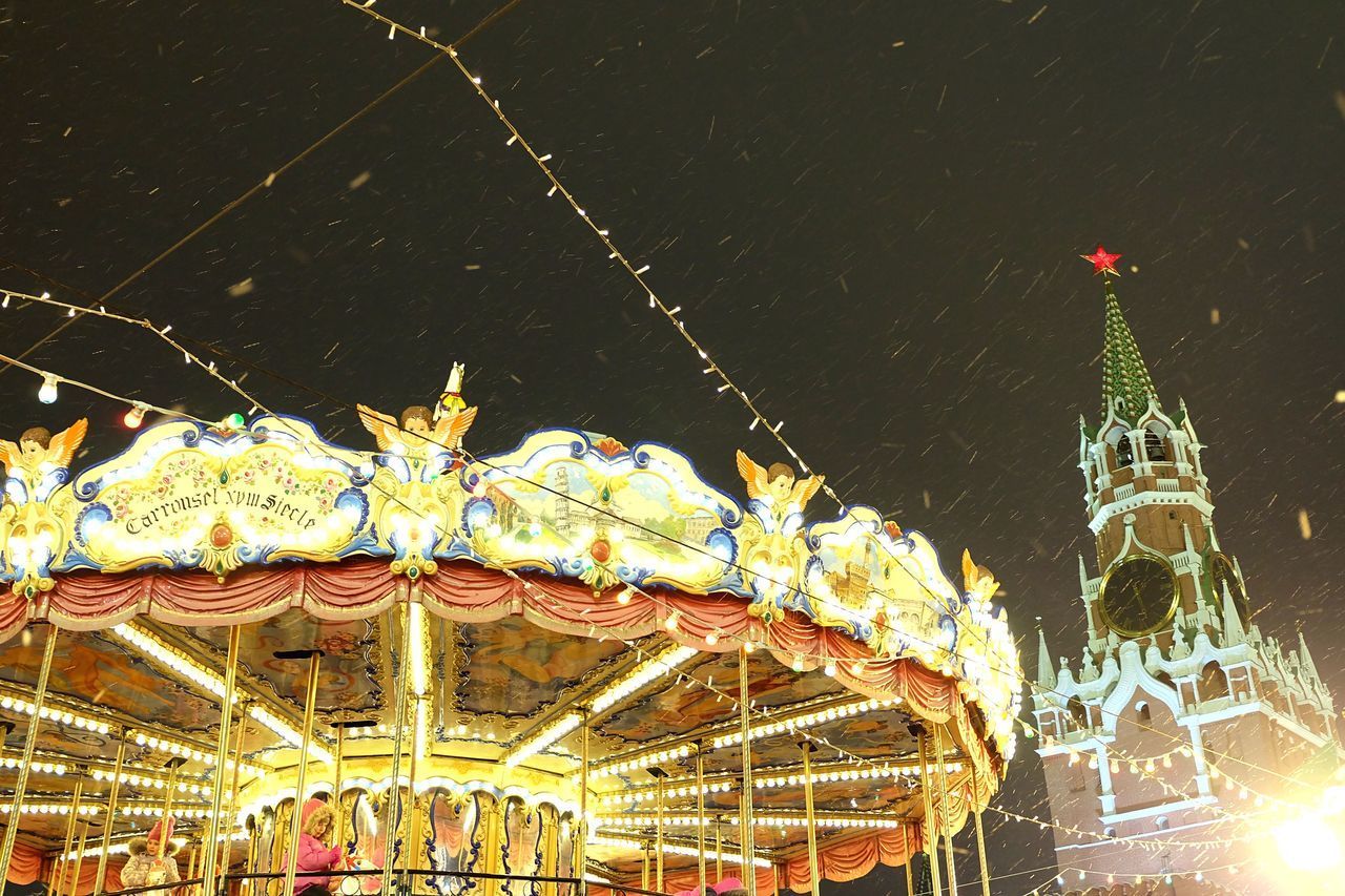 LOW ANGLE VIEW OF ILLUMINATED CAROUSEL