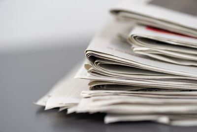 Close-up of newspapers on table