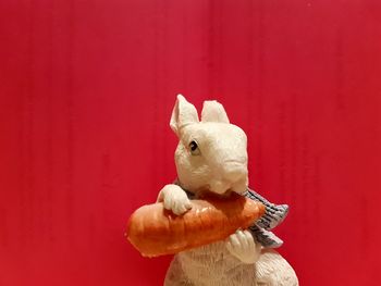 Close-up of stuffed toy against red background