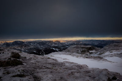 Snowcapped landscape against sky at night