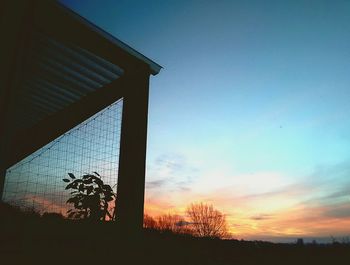 Low angle view of silhouette trees against sky during sunset