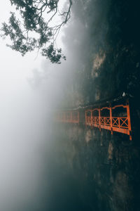 View of bridge over river in foggy weather