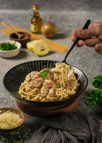 Cropped hand of person having food on table