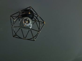 Close-up of illuminated electric lamp against black background