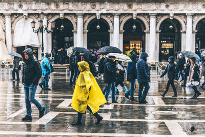 People walking on sidewalk in city