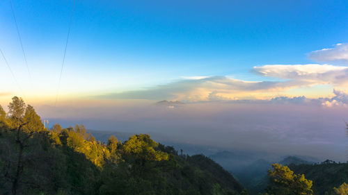 Scenic view of mountains against cloudy sky