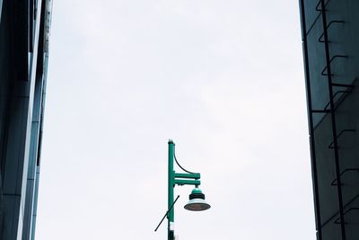 Low angle view of road sign against sky