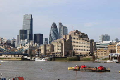 Scenic view of river and buildings against sky