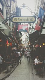 People on street amidst buildings in city