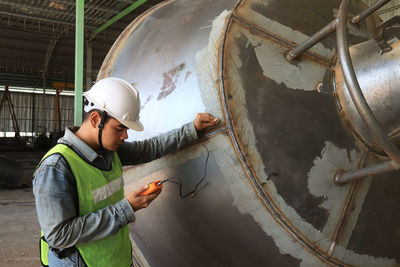 Mechanic engineer in factory checking quality of metals