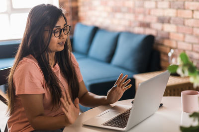 Young woman using laptop at home