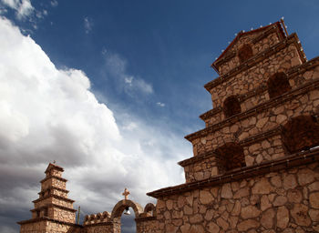 Low angle view of old building against cloudy sky