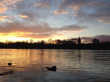 Scenic view of lake at sunset