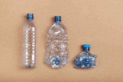 High angle view of plastic bottle against colored background