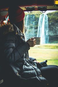 Rear view of woman using mobile phone