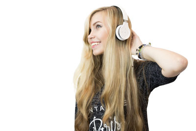 Portrait of smiling young woman against white background