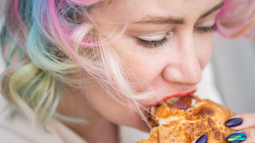 Close-up of woman eating burger